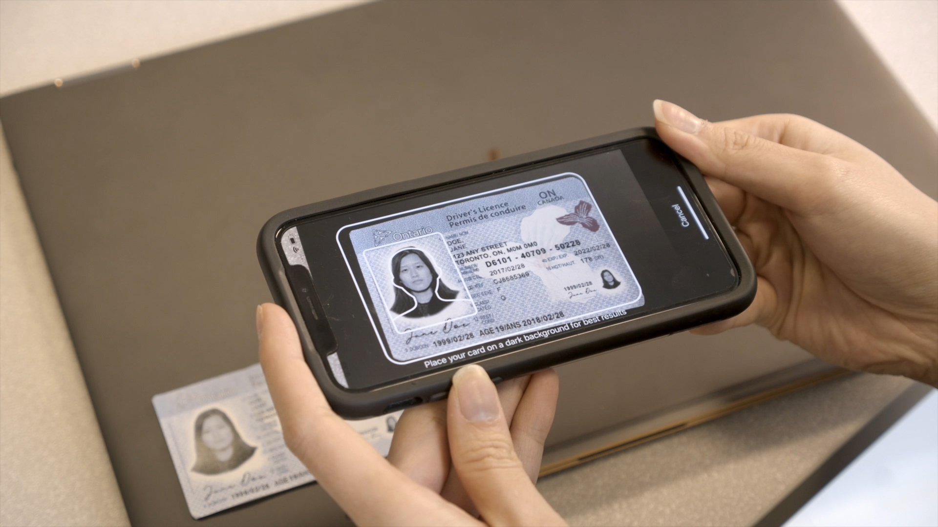 Scanning a driver's licence ID card with a mobile phone.